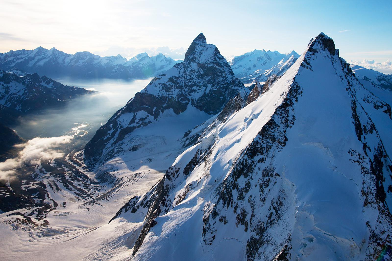 A view of clear blue lakes nestled between jagged Alpine Peaks